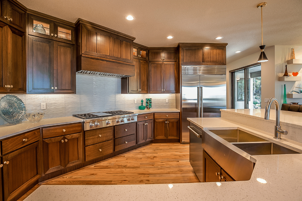 https://www.cabinetdoors.com/product_images/uploaded_images/kitchen-cabinet-color-trends-2024-dark-stained-natural-wood.png